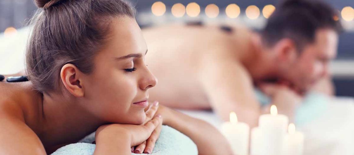 Adult happy couple relaxing in spa salon